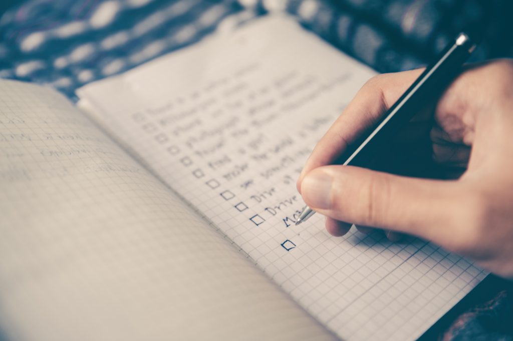 someone writing a todo list