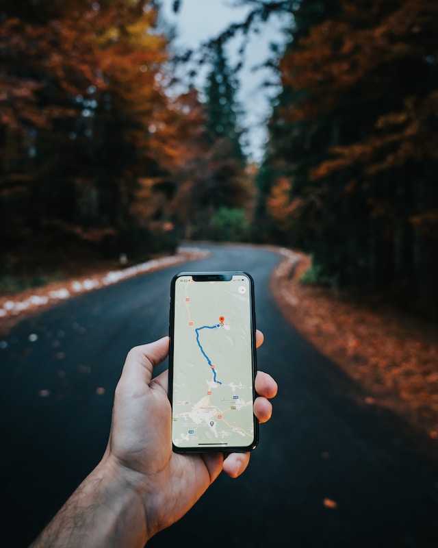 mans arm holding phone map