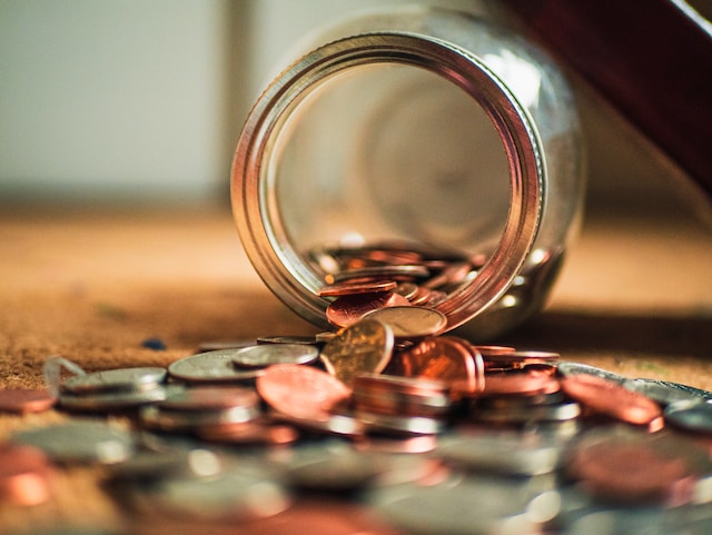 spilled money jar with coins