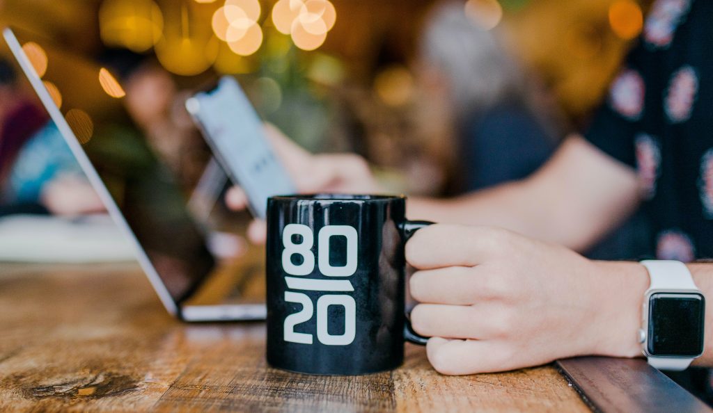 a mug with 80/20 logo