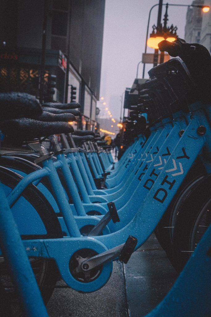 a shot looking down a row of identical blue bicycles