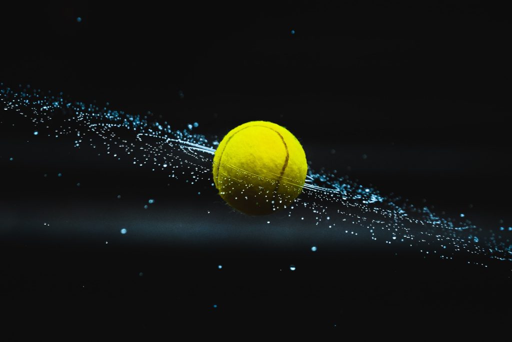 spinning, wet tennis ball still image