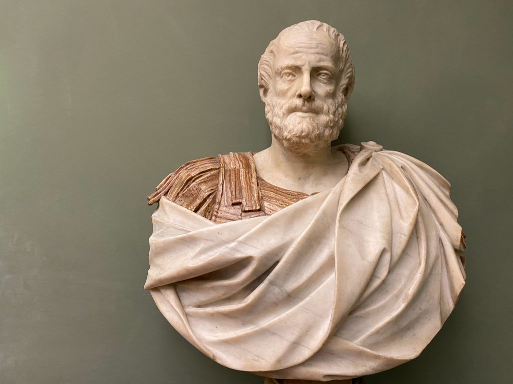 ancient marble bust of a bearded man in a toga
