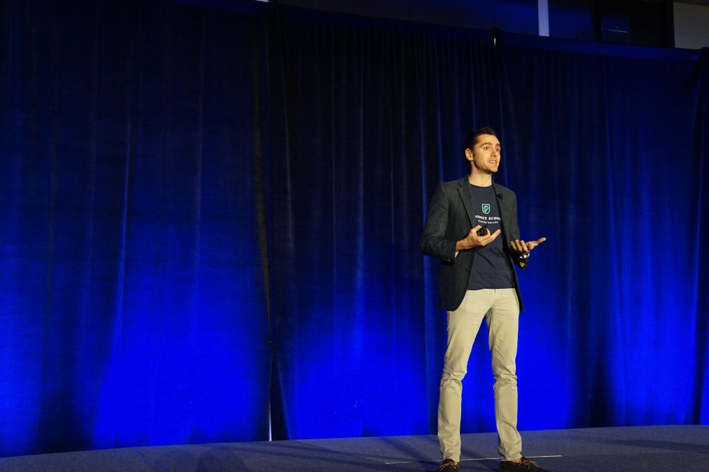 man on stage giving talk