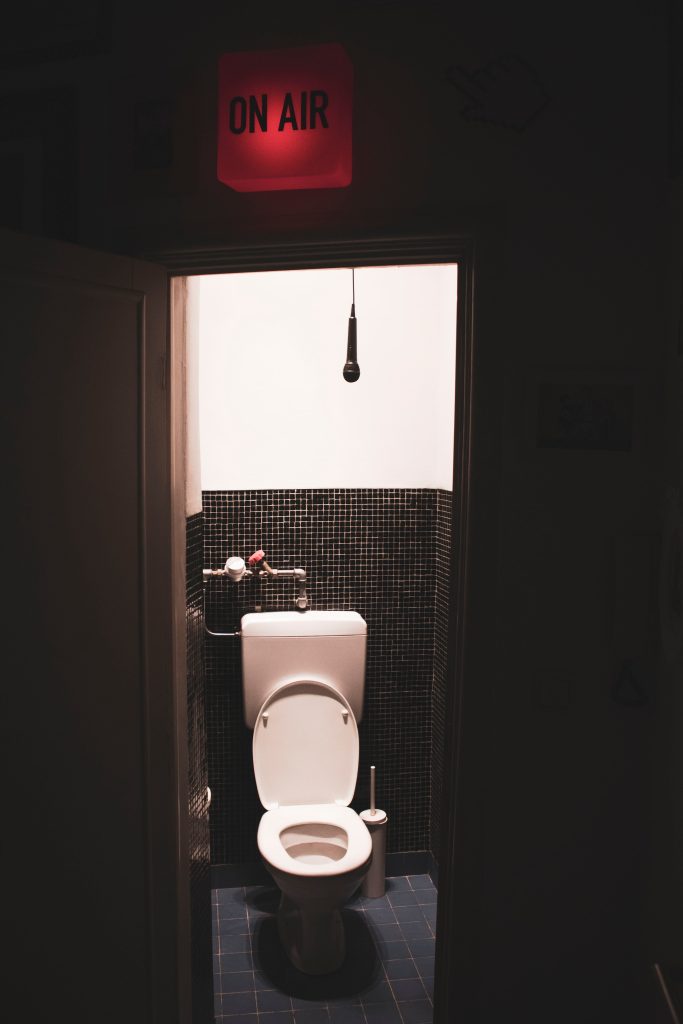 bathroom with "on air" sign above the doorway