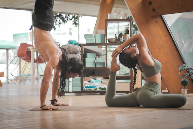 a man and a woman engaging in exercise in a studio