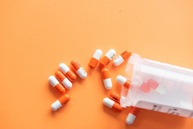 capsule medication bottle spilled on table