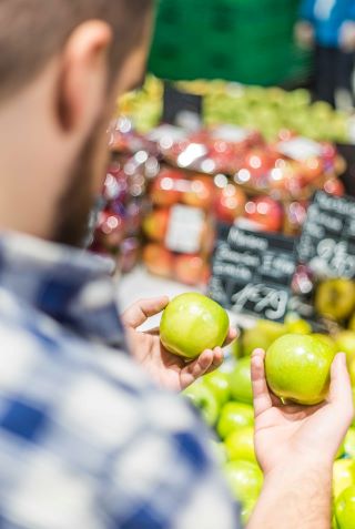 a man comparing apples