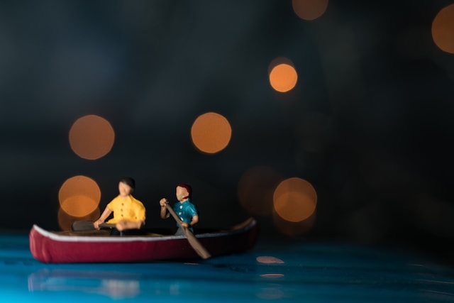 model father and son on toy boat