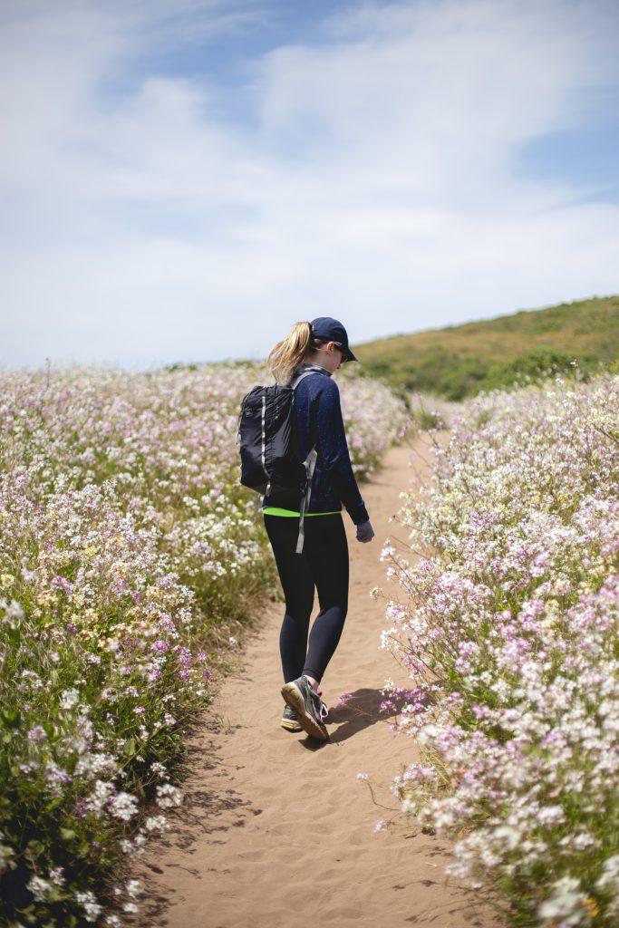woman walking down beach path