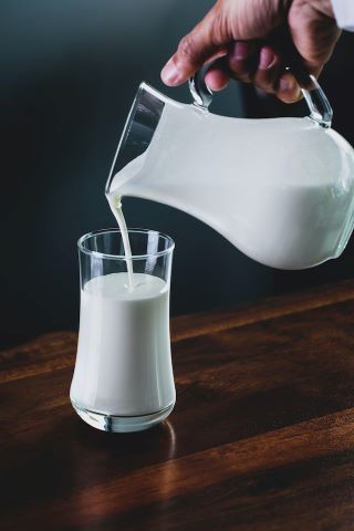 jug of yoghurt pouring into a glass