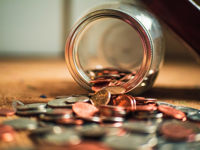 spilled glass jar full of coins